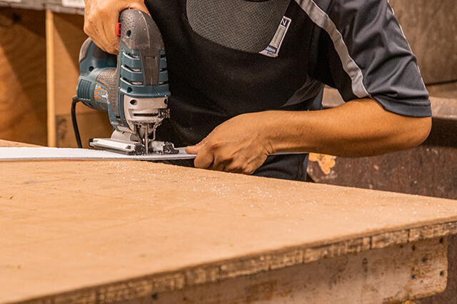 Employee cutting materials for door in Milwaukee store and showroom